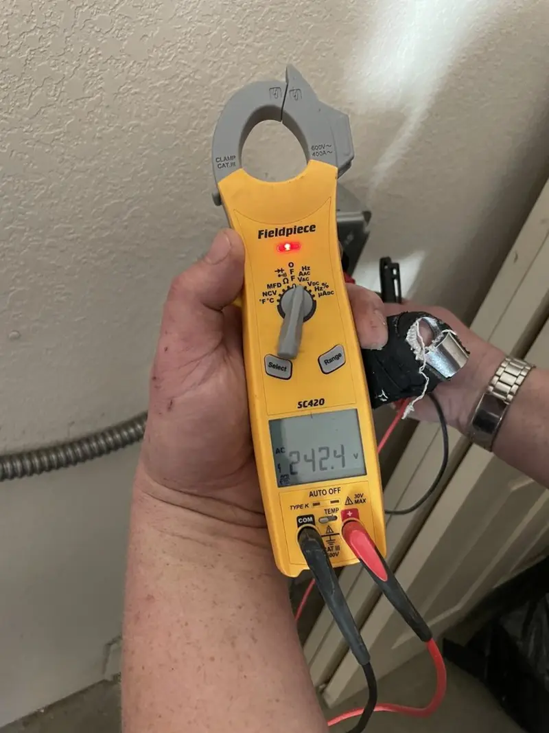 Voltage testing with clamp meter during Electrical Installation Services in Livermore Falls